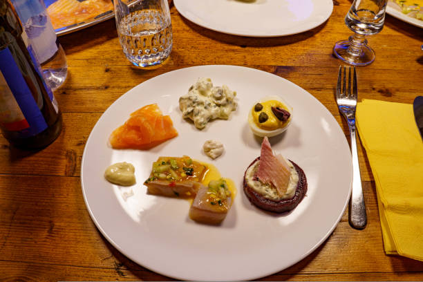 Plate of mixed fish-based appetizers, salmon and stuffed eggs