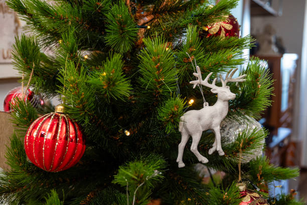 istock A Christmas tree with a white deer ornament hanging from it. 2186426608