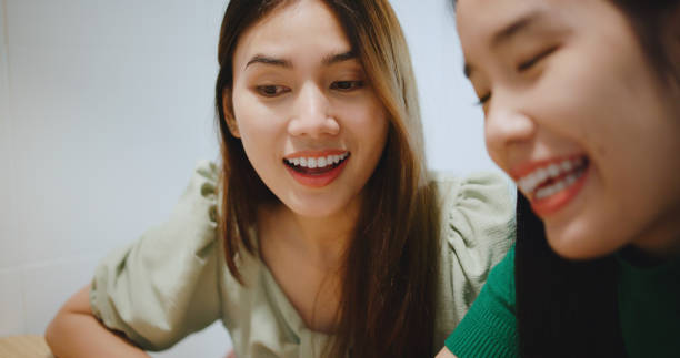 istock Two young women discussing projects or ideas on a tablet in a coffee shop. 2186426792