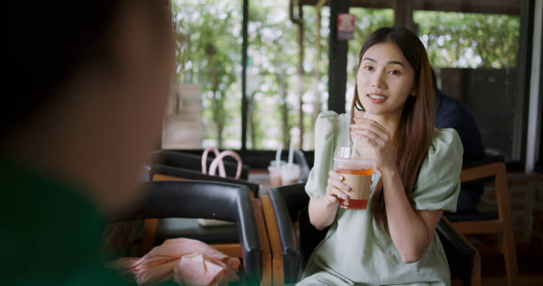 istock Two young women discussing projects or ideas on a laptop in a coffee shop. 2186427222