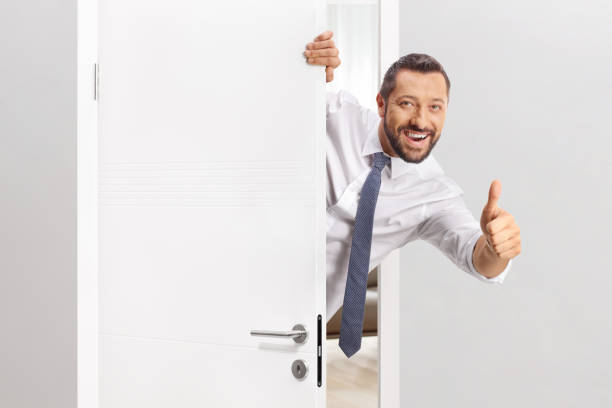 istock Cheerful man opening a door 2186429417