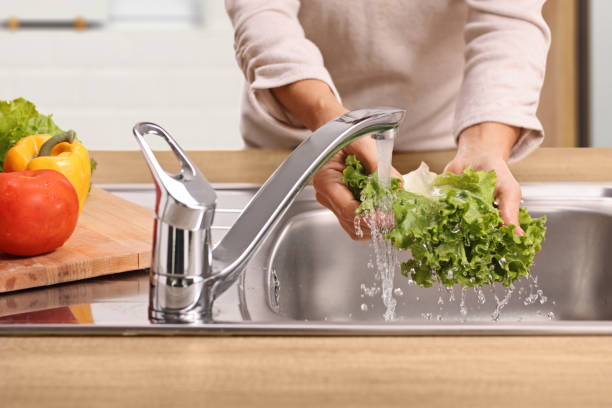 istock Woman washing a lettuce salad 2186429448