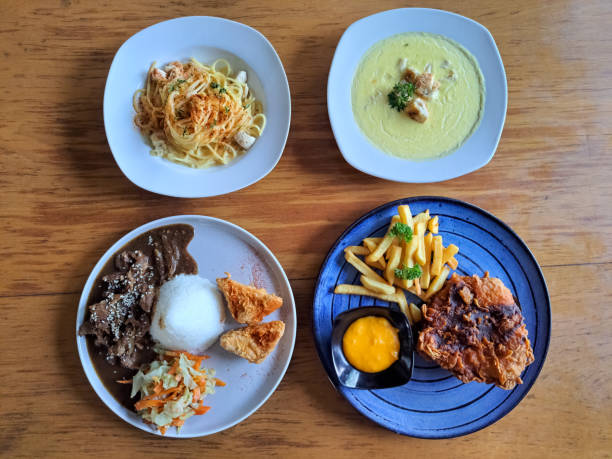 istock Spaghetti Alfredo With Chicken, Corn Soup With Crouton, Beef Bulgogi With Steamed Rice, Nashville Hot Chicken With French Fries And Cheese Sauce. Food Menu. Top View. 2186432886