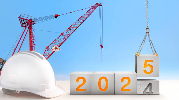 istock construction-crane are lifting year 2025 in concrete cube replace the passed year 2024. new year party and change new business for modern city and environment friendly. 2186433720