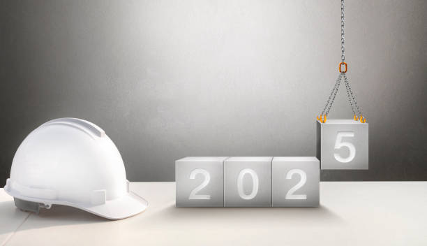 istock Happy New Year 2025 Construction and Industry. White Helmet and a numbered concrete cube on the desk of an engineer or construction worker. building with Cranes construction concept. 2186433736