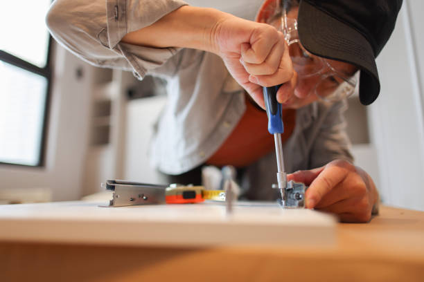 istock Man assembles furniture in new home 2186434632
