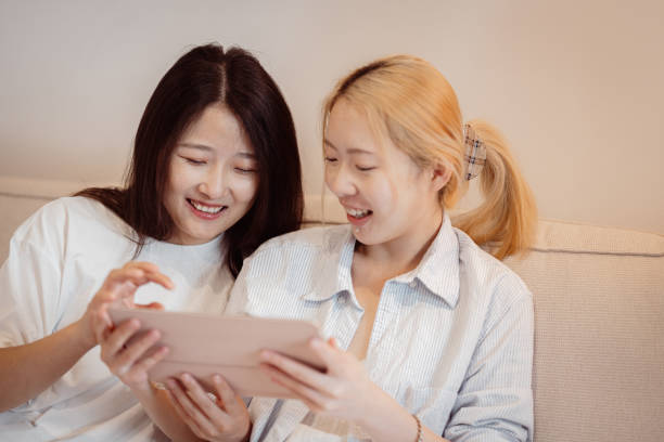 istock Female friends bonding over shared interests on a tablet 2186437992