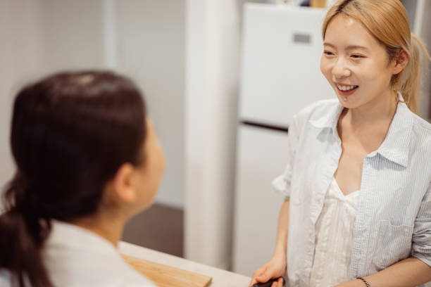 istock Female friends sharing a cheerful conversation in the kitchen 2186438168