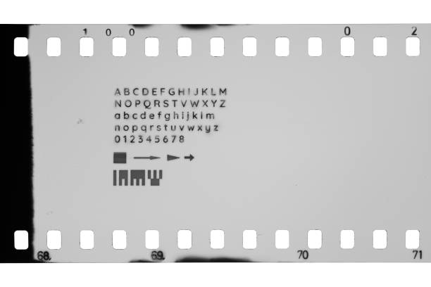 35mm film with perforations and different letters, digits, symbols marks isolated on white background.