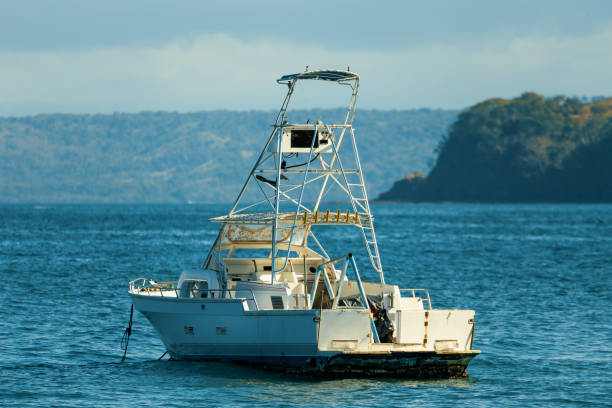 Motor boat anchored on Ocotal beach, view of Pacific ocean, El Coco Costa Rica. Pura Vida concept, travel to exotic tropical country.
