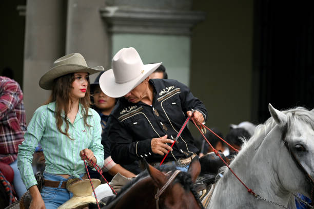 Cowgirl riding a horse in a rodeo arena. Barrel racing at a local competition.
