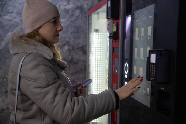 istock Woman stands by coffee vending machine 2186444697