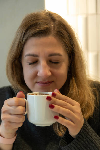 istock Woman holds cup of coffee 2186445299