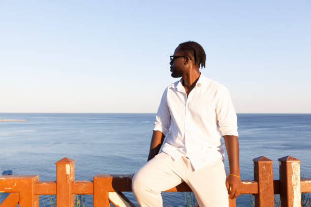 istock Portrait of afro men sitting fence 2186445839
