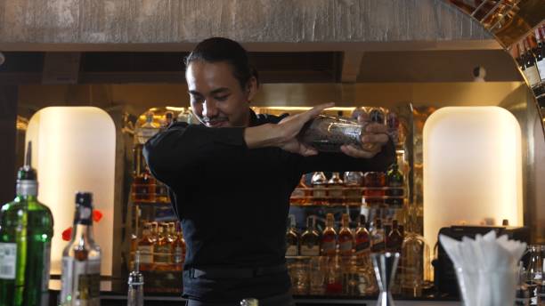 istock Asian bartender shaking mixed cocktail preparing to serve preparation. Vinosity. 2186447310