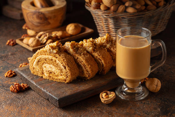 Dessert with walnuts and coffee latte on a vintage background. Cake with brown sugar, walnuts, and cream.