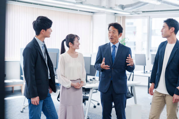 istock Teams chatting amicably in the office 2186448173