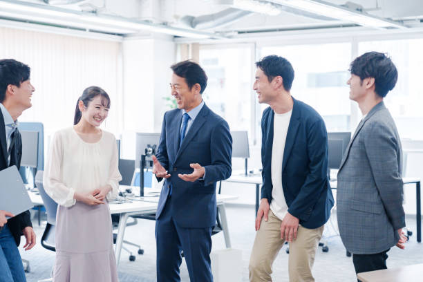 istock Teams chatting amicably in the office 2186448179