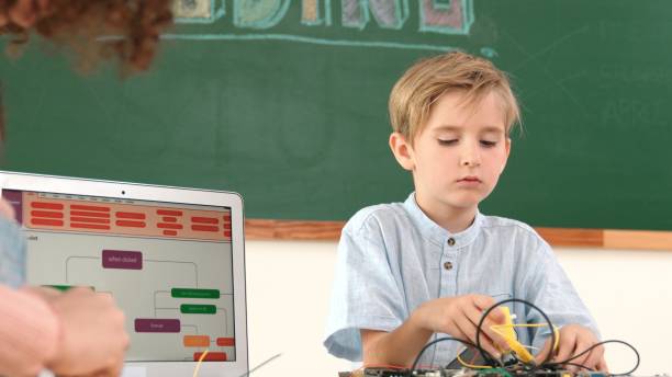 istock Caucasian boy fixing main board by using screwdriver at stem lesson. Pedagogy. 2186448267