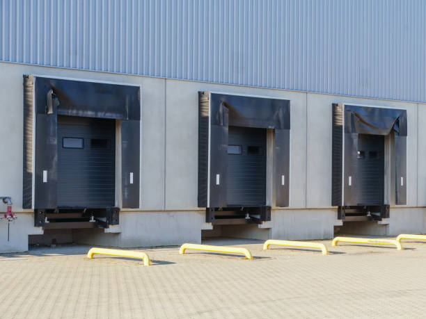 istock hree loading dock doors on an industrial building, featuring black dock seals and yellow protective barriers 2186451072