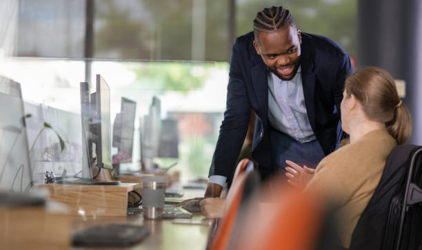 istock Inclusive Teamwork Scene with Business Executive and Wheelchair-using Colleague 2186452422