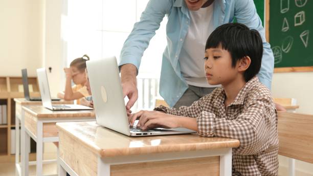istock Caucasian teacher helping asian student coding engineering prompt. Pedagogy. 2186452426