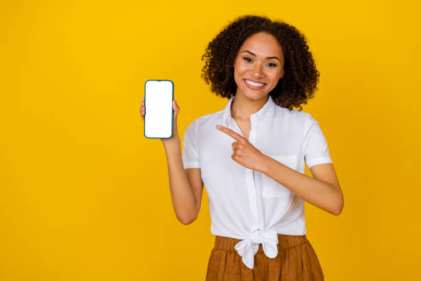 istock Photo of charming nice person indicate finger empty space telephone display isolated on yellow color background 2186452602