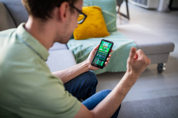 istock Excited man with smartphone celebrating success joyfully 2186456343