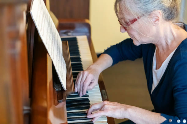istock Female pianist  playing  piano at home 2186456935