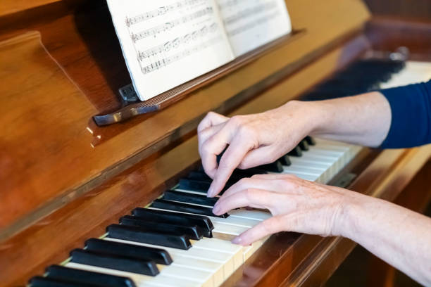 istock Female pianist  playing  piano at home 2186456971