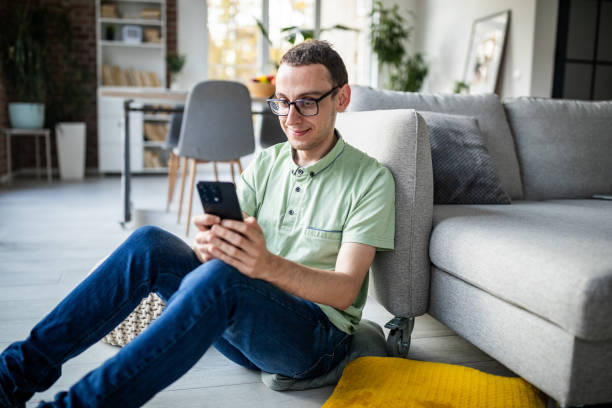 istock Man enjoying a moment with his smartphone indoors 2186457081