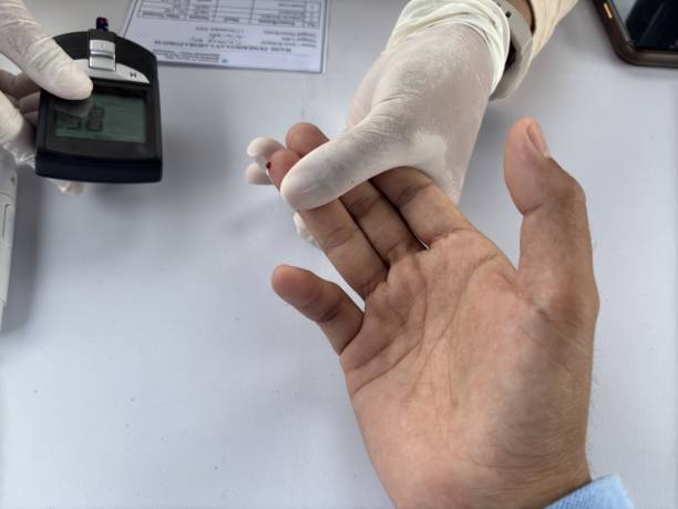 Doctor use digital glucose monitor measure and test stripe for check diabetes from finger blood sugar level.