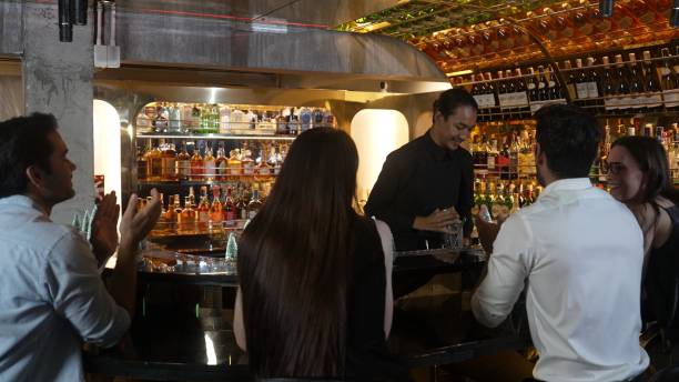 istock Smiling Asian bartender preparing mixed cocktail with christmas tress. Vinosity. 2186459535