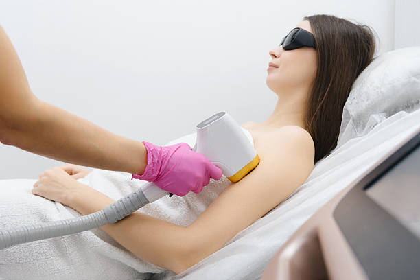 istock young woman on laser epilation procedure 2186461091