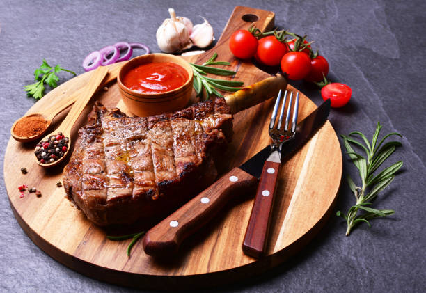 istock Tomahawk steak with spices and vegetables 2186463460