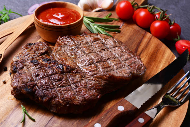 istock Ribey steak with spices and vegetables 2186463463