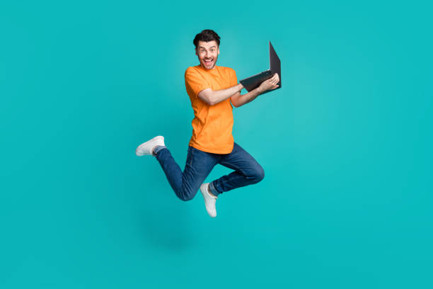 istock Full size photo of jumping guy using netbook impressed e commerce web discount isolated on cyan color background 2186471057