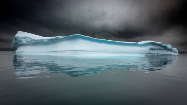 istock Iceberg floating under dark skies 2186482666
