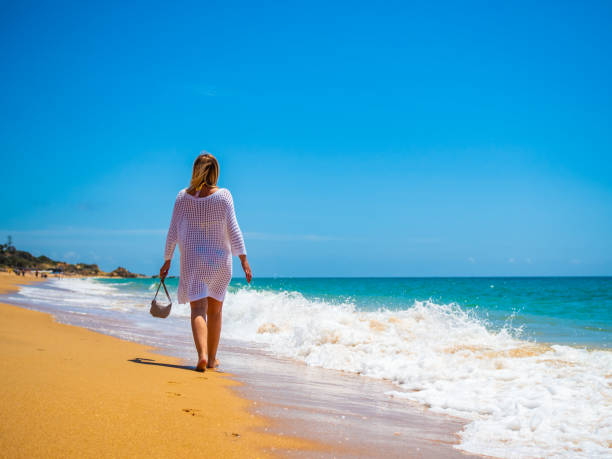 istock Beautiful mature woman walking on beach 2186483448