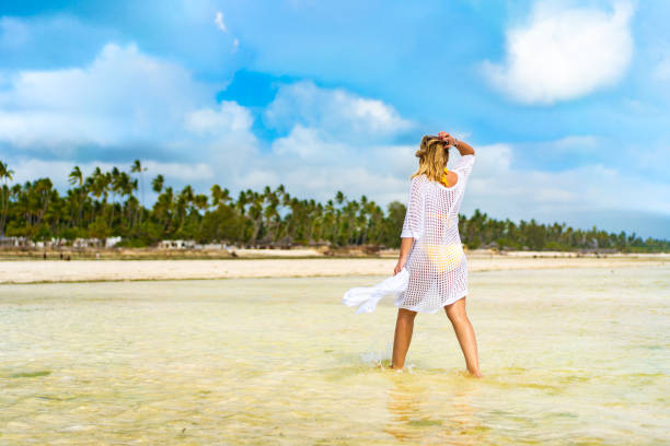 istock Beautiful mature woman walking on beach 2186483537