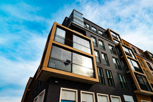 istock Modern Apartment Building with Glass Balconies and Industrial Elements. 2186483766