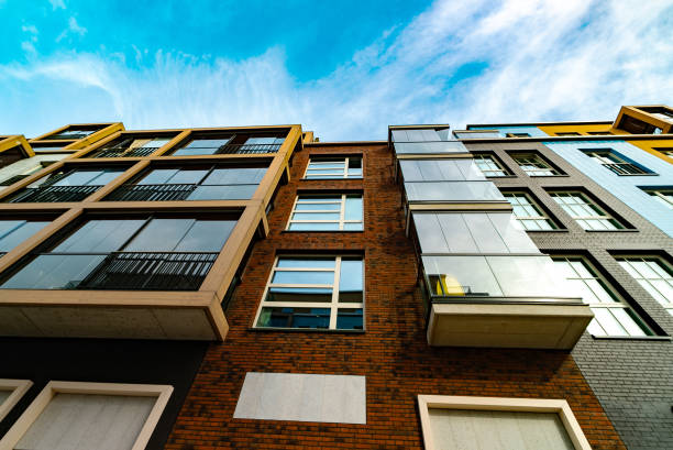Modern Apartment Building with Glass Balconies and Industrial Elements.
