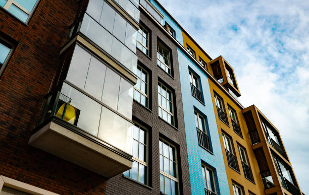 istock Modern Apartment Building with Glass Balconies and Industrial Elements. 2186483783