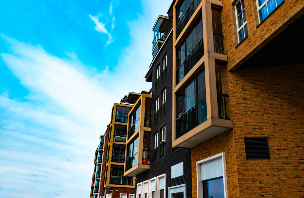 istock Modern Apartment Building with Glass Balconies and Industrial Elements. 2186483785