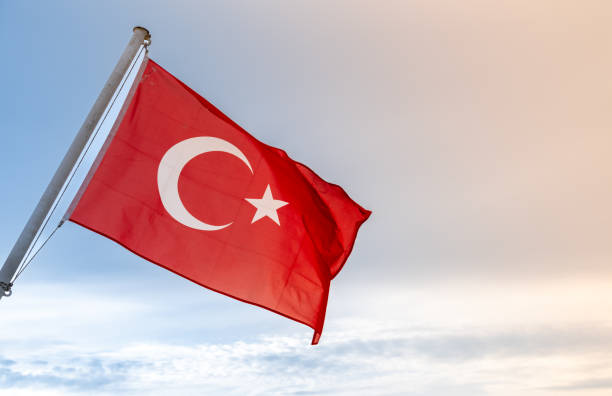 istock A Turkish flag waving in the wind against a clear blue sky 2186483862