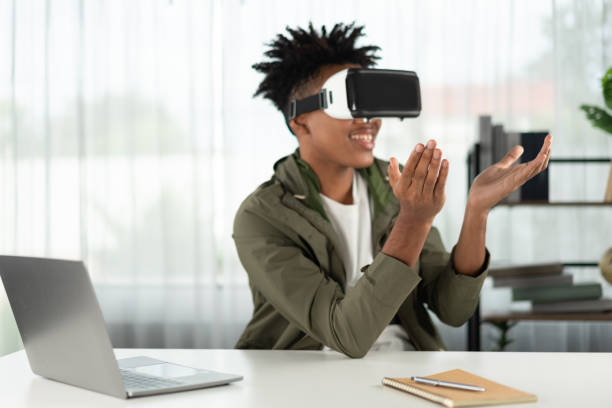 istock African American looking through VR holding interesting data meta. Contrivance. 2186488011