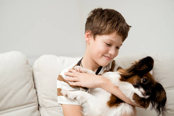 istock A happy Caucasian boy hugs his dog. 2186488457