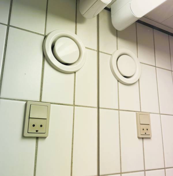 Electrical outlet and wall-mounted fan in a bathroom