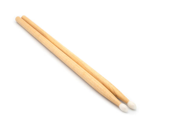 A close-up of hickory drum sticks, ideal for music education posters, music school announcements, or promoting drumming classes and musical instruments.