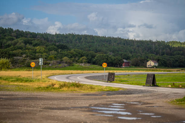 istock Curved road across a field.. 2186497578